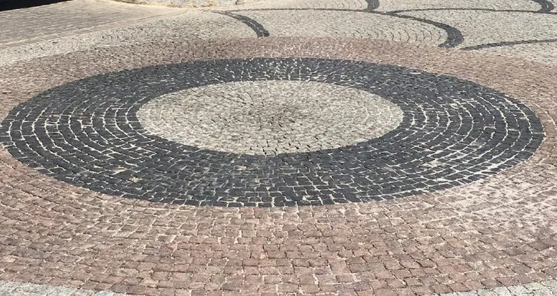 Red and black basalt setts laid in a fan pattern