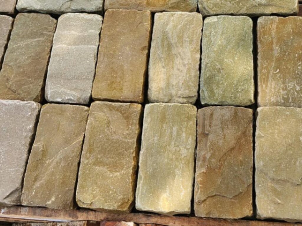 Sandstone walling blocks showing the natural buff, brown and grey tonal range