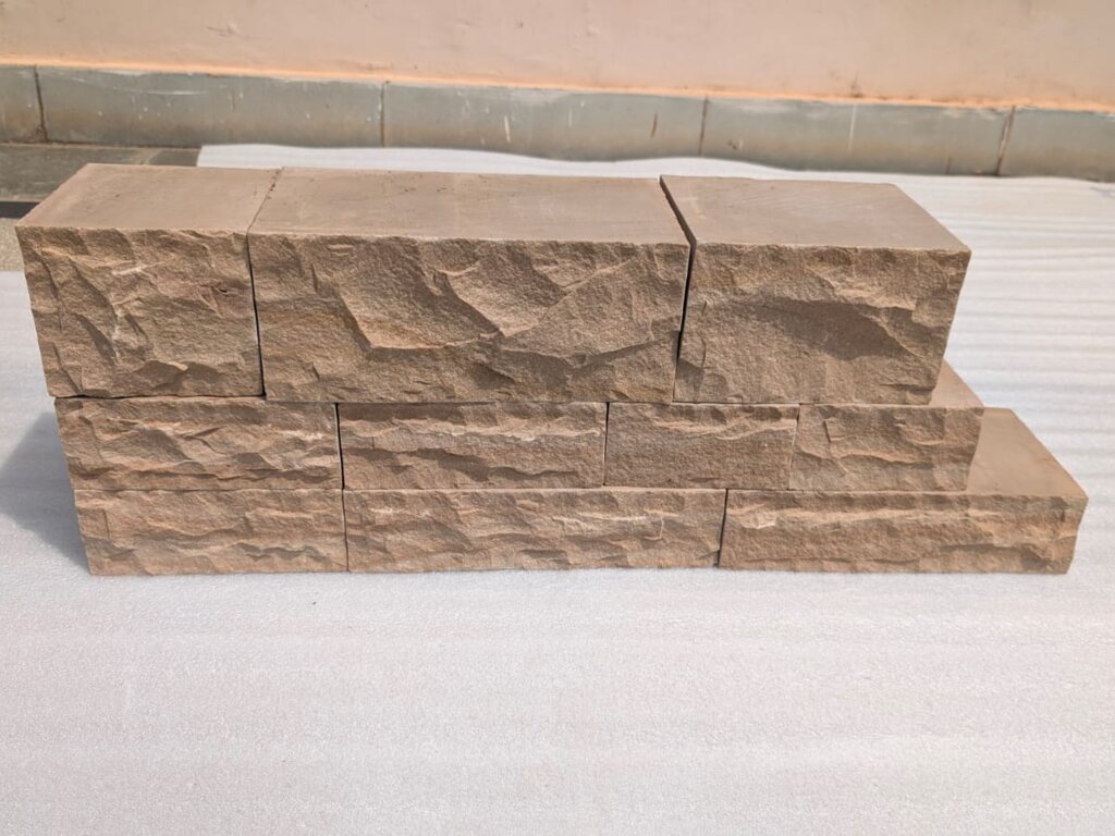 Buff sandstone walling blocks, split face with sawn beds and ends